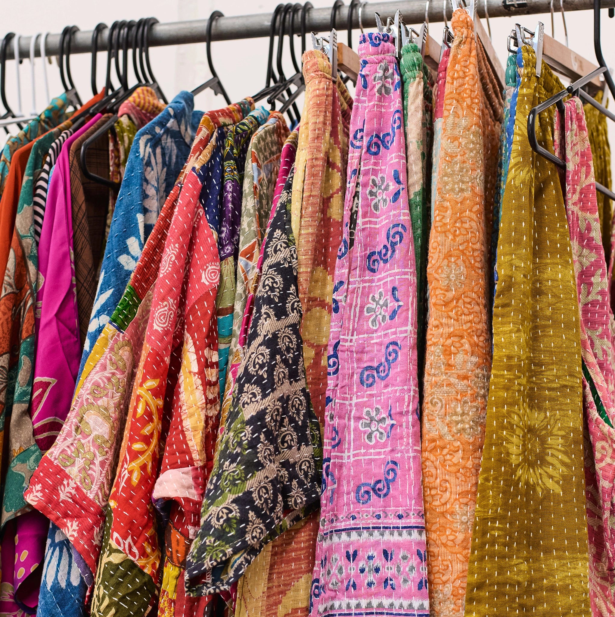 Colorful patterned fabrics hanging on a rack
