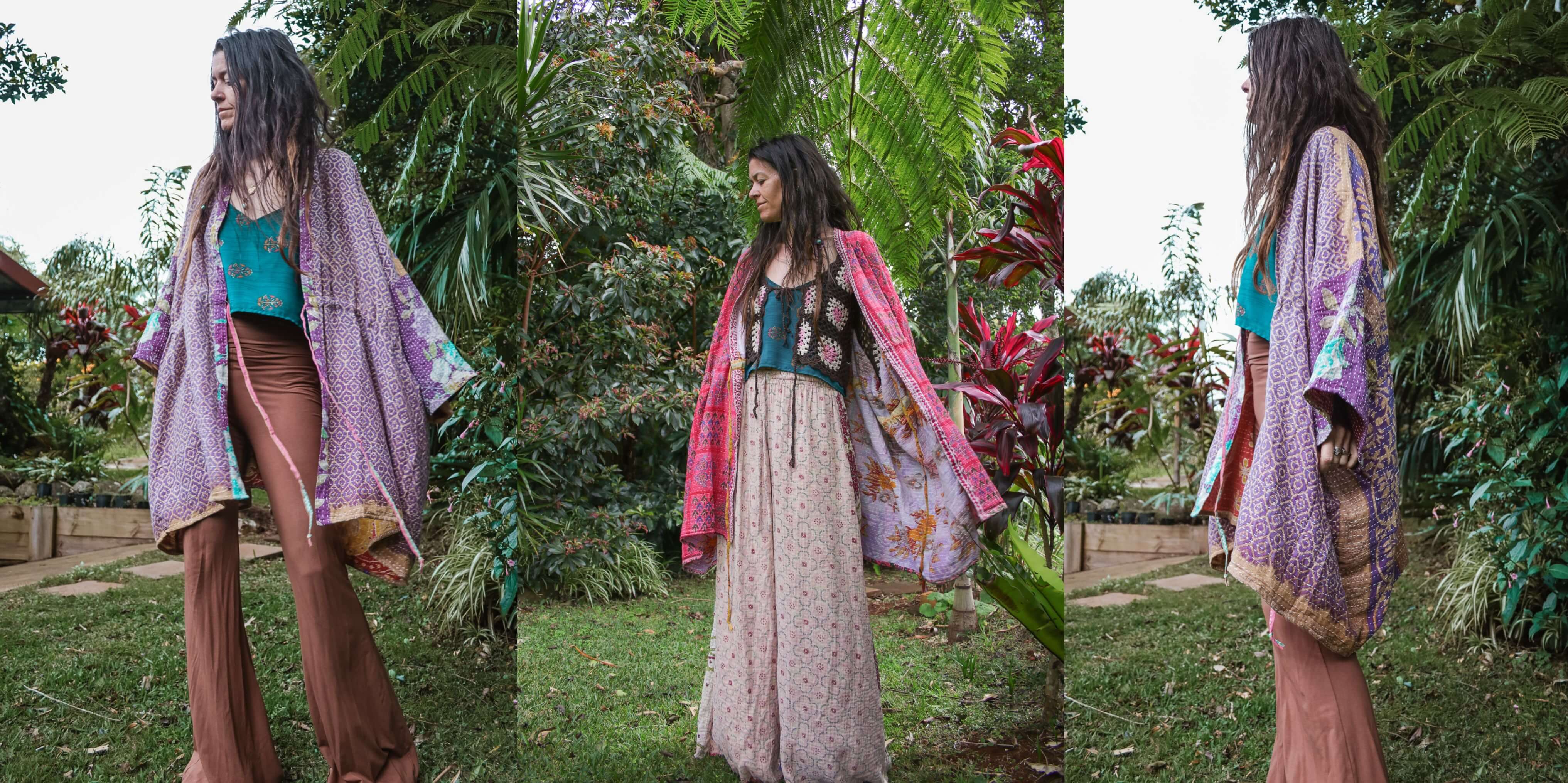 Woman in a garden wearing a floral kimono-style jacket over a green top and brown pants.