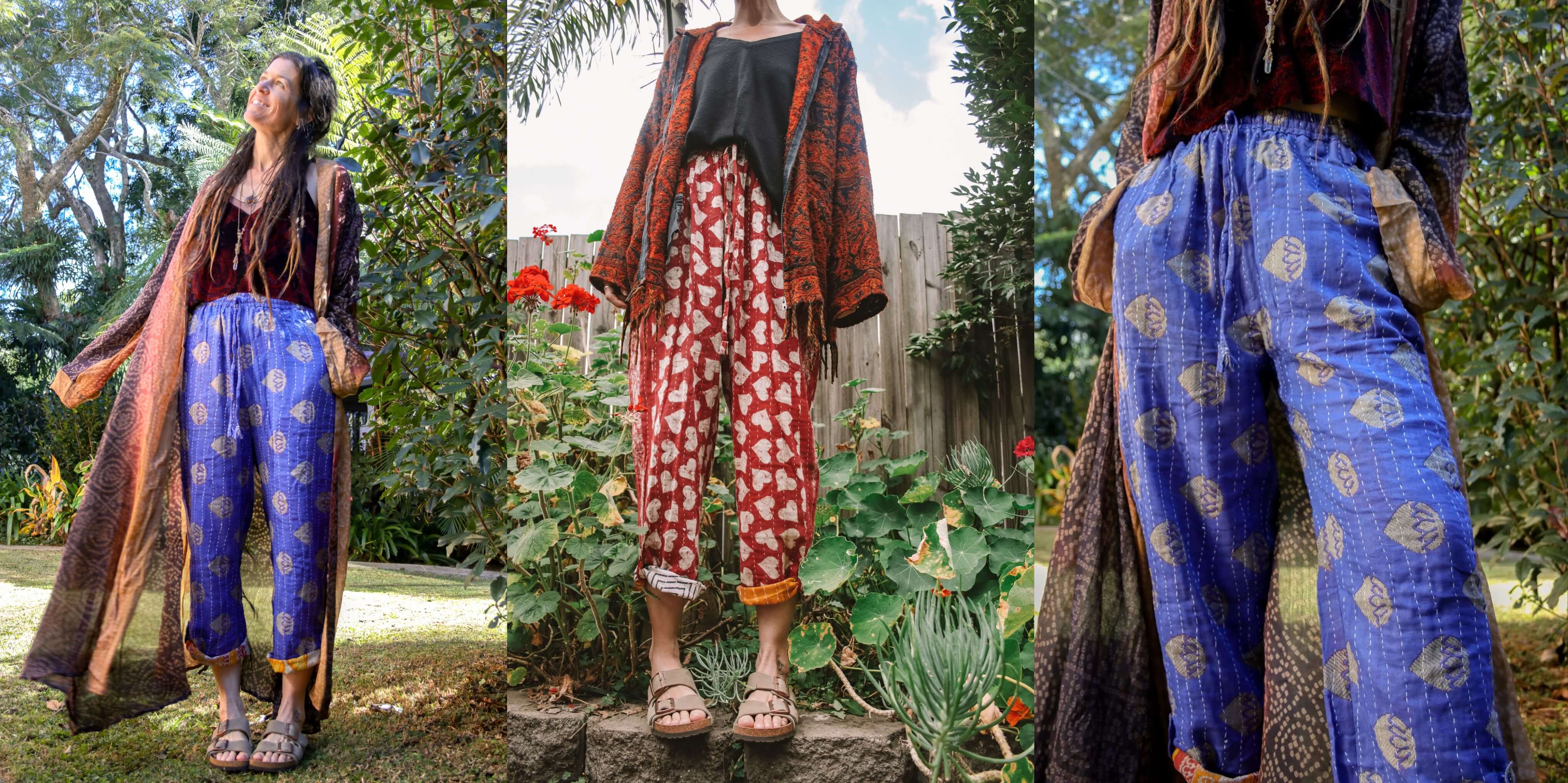 Woman wearing a patterned outfit with blue pants and a long jacket in a garden setting.