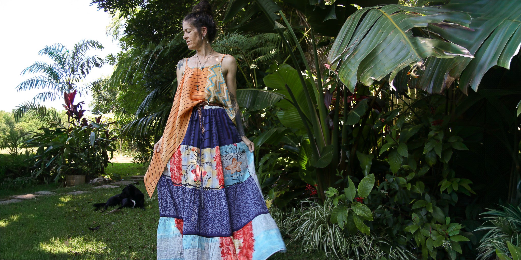 Woman in a colorful dress standing in a garden