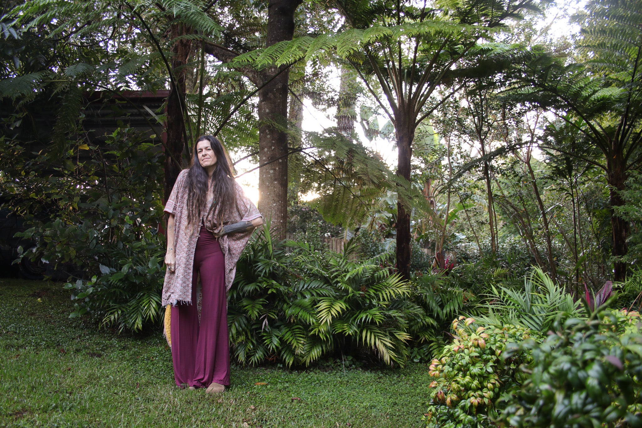 Woman standing in a lush green forest